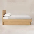 Side view of Caldrin Fluted Bed in Natural Sheesham finish with a clean wooden platform frame.