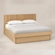 Angled view of Caldrin Fluted Storage Bed in Natural Sheesham finish with fluted headboard and built-in storage base.