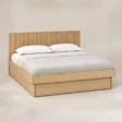 Angled view of Caldrin Fluted Storage Bed in Natural Sheesham finish with fluted headboard and built-in storage base.