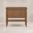 Back view of Aldren wooden bedside table with open lower shelf, turned legs, and warm brown finish.