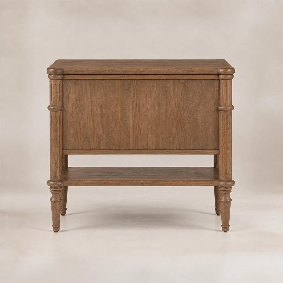 Hugo-Platform-sidetable-back-side-view Back view of Aldren wooden bedside table with open lower shelf, turned legs, and warm brown finish.
