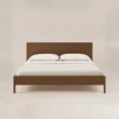 Front view of Kelden Linea Bed in Walnut Brown finish with clean panel headboard and slim wooden legs.