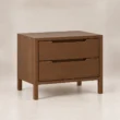 Angled view of Kelden Linea matching two-drawer bedside table in Walnut Brown finish with recessed handles and slim wooden legs.