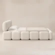 Angled view of Mirelle Upholstered Bed in ivory boucle fabric.