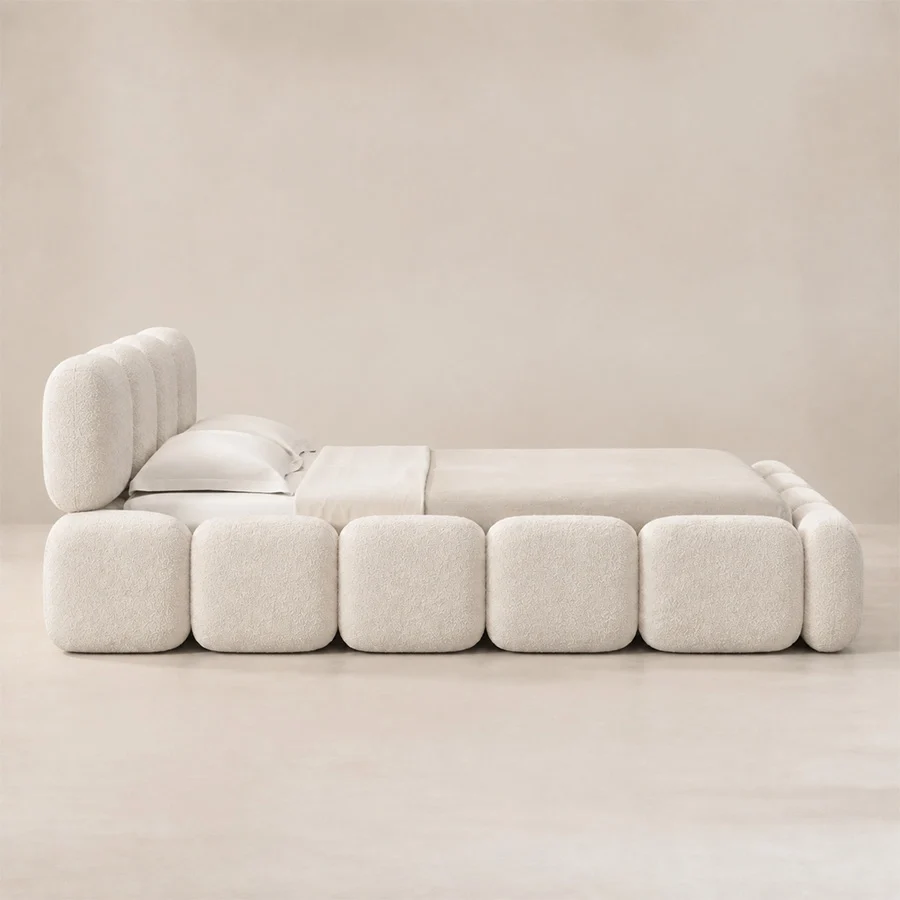Mirelle Bed side view Angled view of Mirelle Upholstered Bed in ivory boucle fabric.