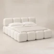 Angled view of Mirelle Upholstered Bed in ivory boucle fabric.