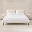 Nolven Softline Bed Set in warm ivory upholstery with matching two-drawer bedside tables, front view.