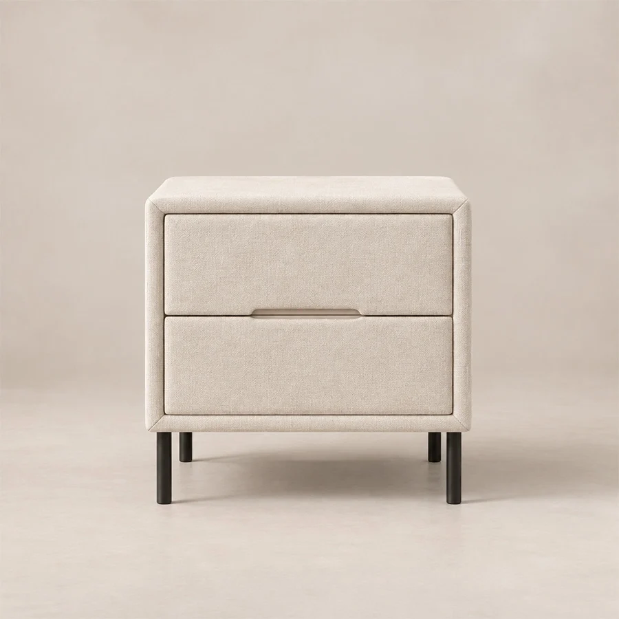 Nolven Softline Off-White side table Nolven Softline matching two-drawer bedside table in warm ivory upholstery with slim black metal legs.