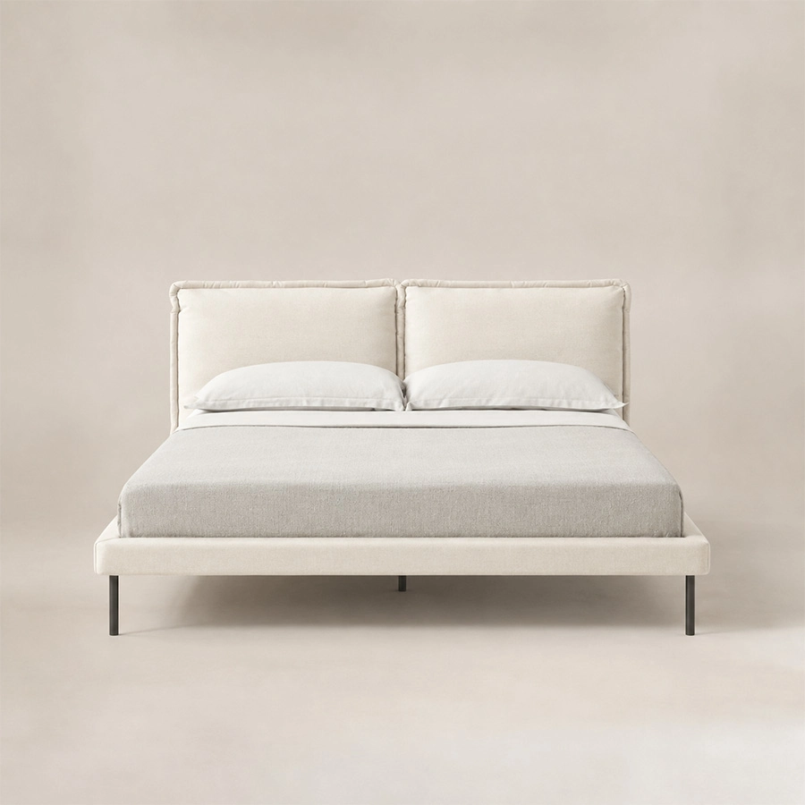 Front view of Nolven Softline Upholstered Bed in warm ivory fabric with a soft padded headboard and slim metal legs.