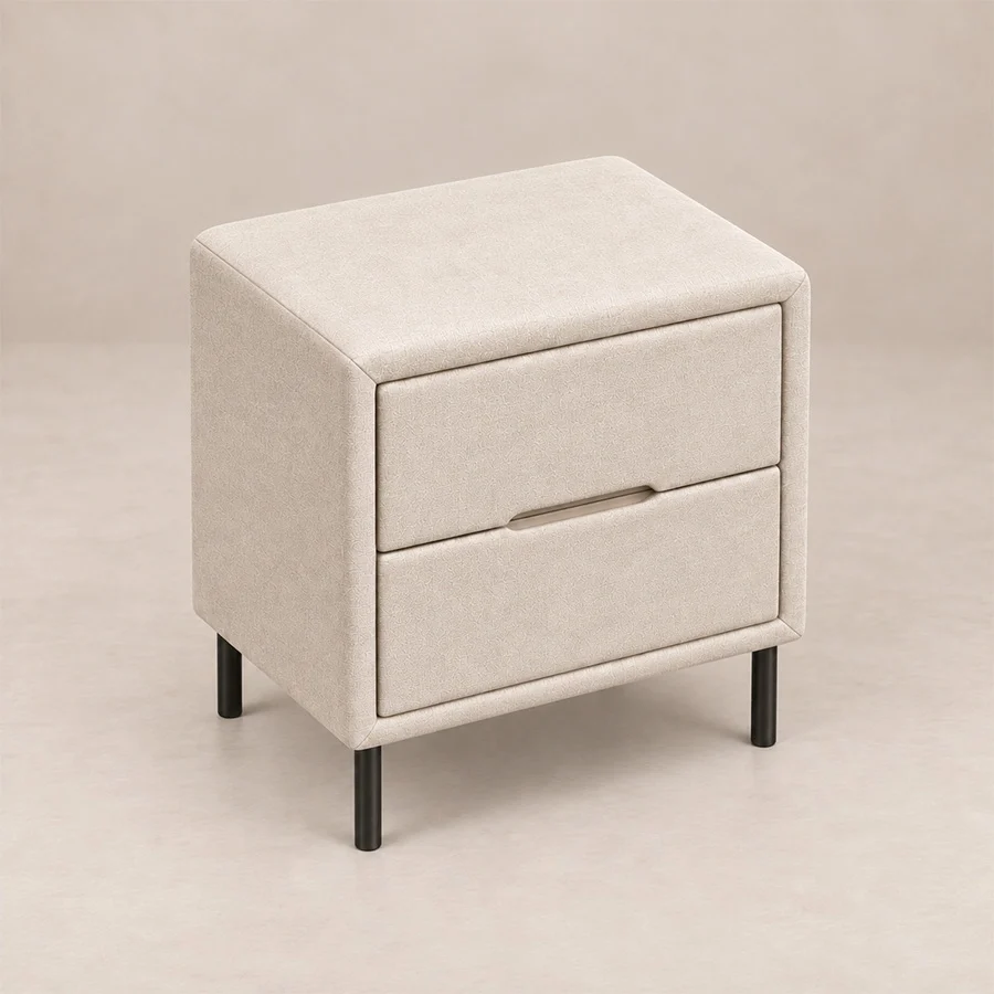 Nolven Softline upholstered Off-White sidetable Angled top view of Nolven Softline matching two-drawer bedside table in warm ivory upholstery with slim black metal legs.