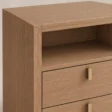 Close-up of Soreven Archline bedside table in Warm Walnut finish with open shelf and brass drawer handles.