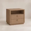 Angled view of Soreven Archline bedside table in Warm Walnut finish with open shelf, two drawers, and brass handles.