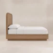 Side view of Soreven Archline Bed in Warm Walnut finish with arched headboard and low wooden frame.