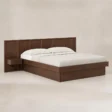 Angled view of modern wooden storage bed with panel headboard and integrated bedside shelf.