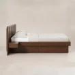 Side view of Veyran Wooden Storage Bed with dark wood frame, integrated bedside shelf, and under-bed storage.