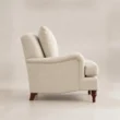 Full side view of Beige Langmere English Armchair showing curved upholstered frame