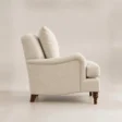 Full side view of Beige Langmere English Armchair showing curved upholstered frame