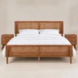Maroven Grid Bed Set in warm wood finish with woven cane headboard, matching cane footboard, and two bedside tables.