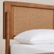 Close-up of Maroven Grid Bed Set showing the warm wood frame and woven cane headboard detail.