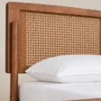 Close-up of Maroven Grid Bed Set showing the warm wood frame and woven cane headboard detail.