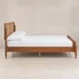 Side view of Maroven Platform Grid Bed in warm wood finish with woven cane headboard, raised wooden frame, and tapered legs.