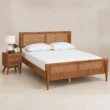 Angled view of Maroven Grid Bed Set in warm wood finish with woven cane headboard, footboard, and matching bedside table.